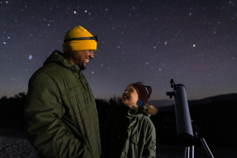 Father and daughter looking at the stars