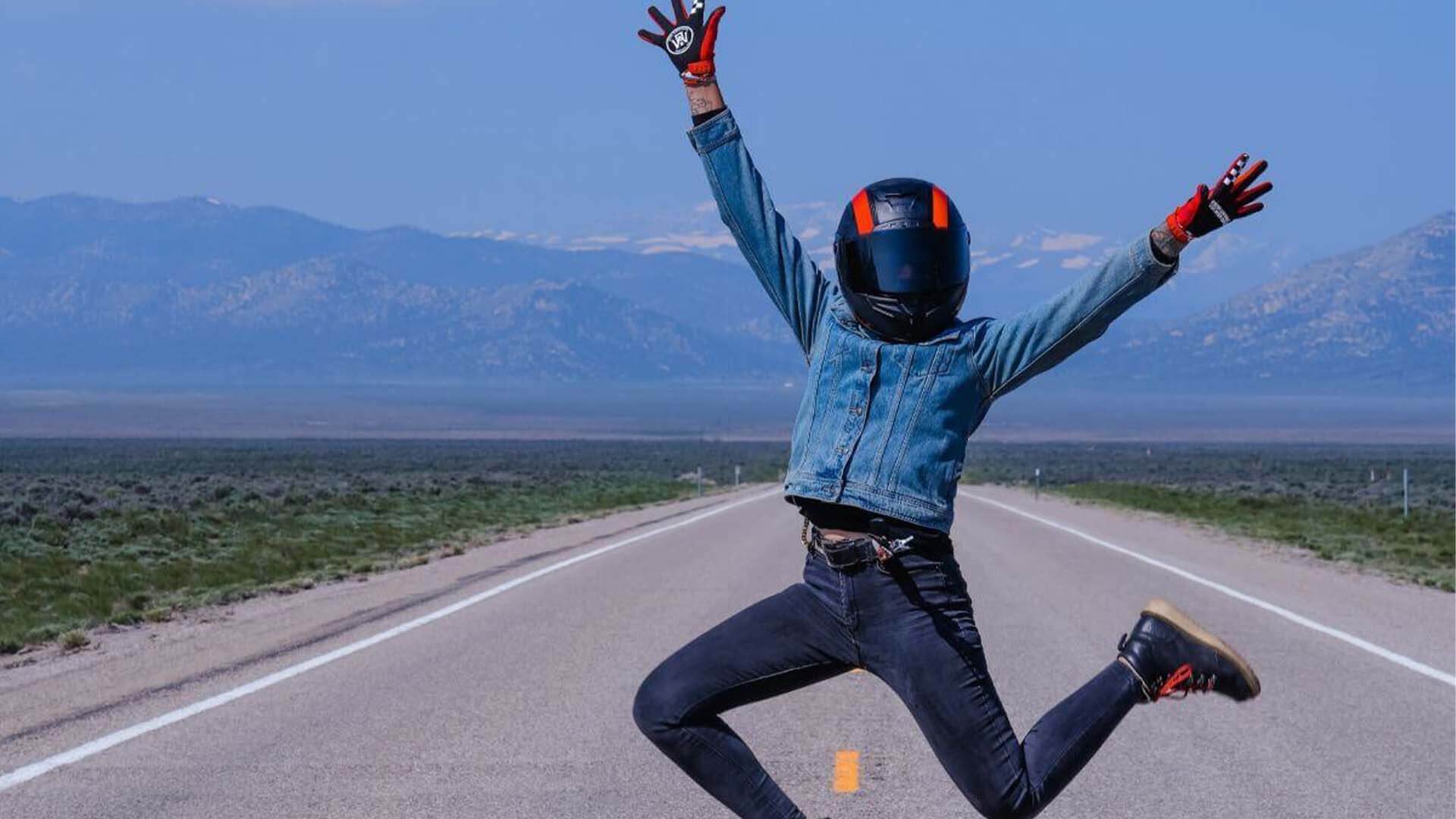 Person jumping in the middle of an empty highway.