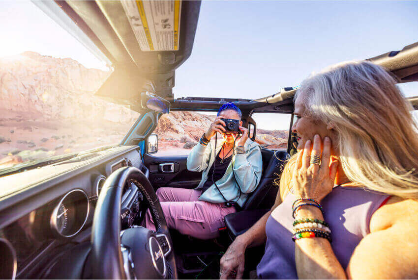 Friends in a Jeep taking photos.